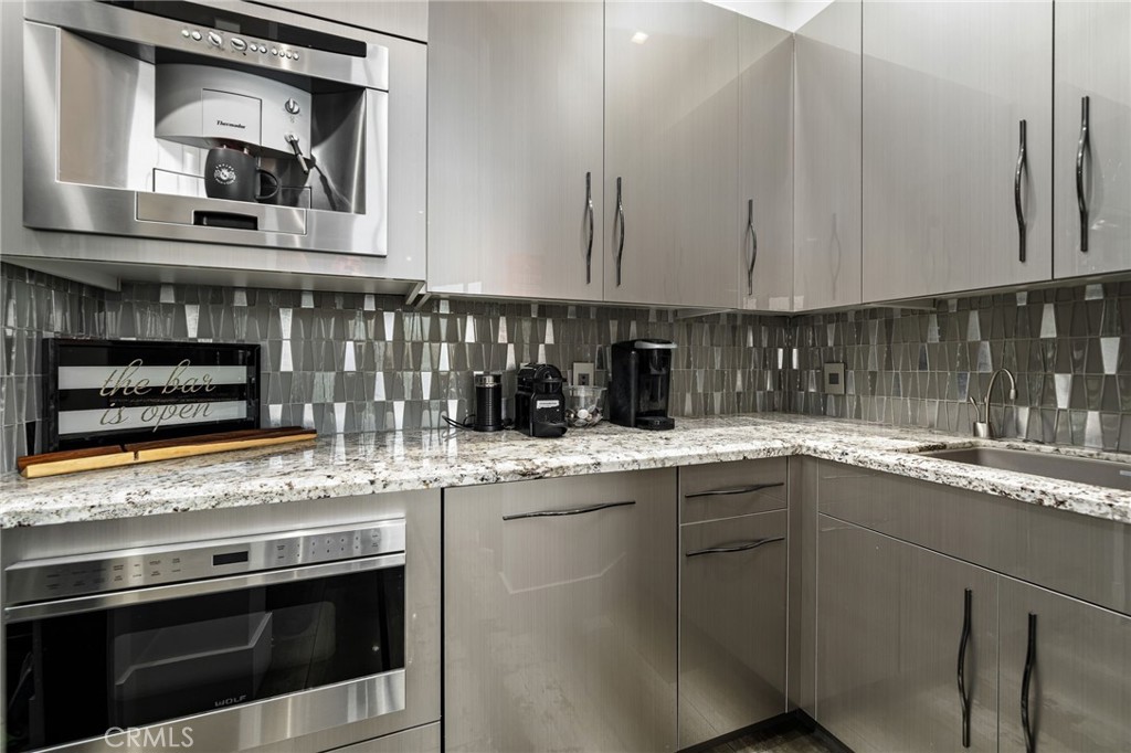 49967 Ridge View Way Palm Desert, CA 92260 - Photo 25 of 68 a kitchen with stainless steel appliances granite countertop a stove and a sink