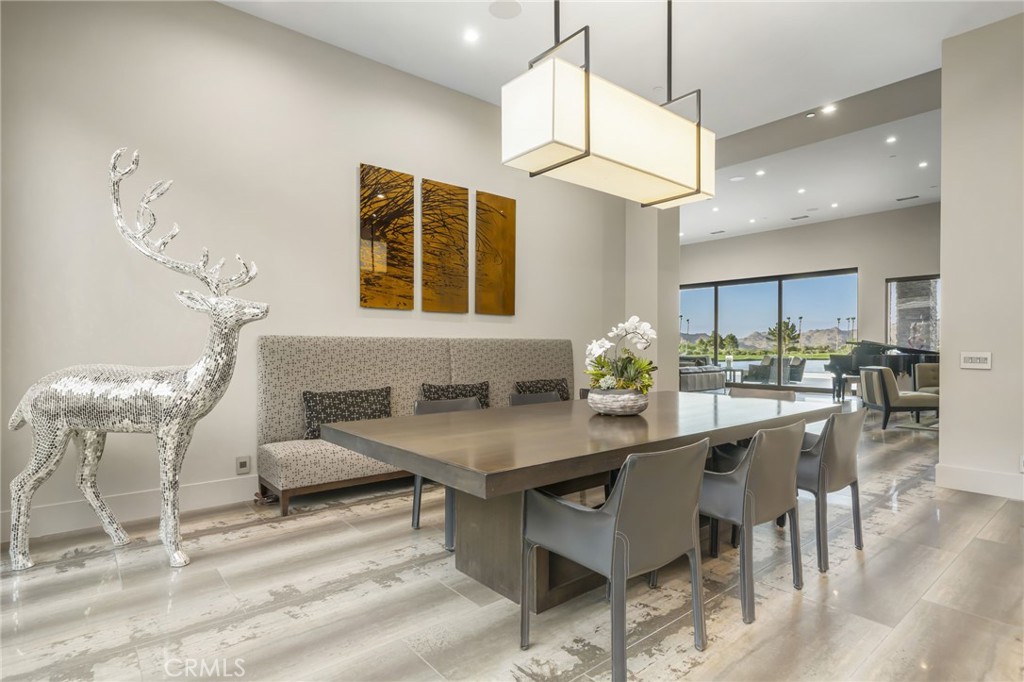 49967 Ridge View Way Palm Desert, CA 92260 - Photo 32 of 68 a kitchen with stainless steel appliances kitchen island granite countertop a table and chairs in it