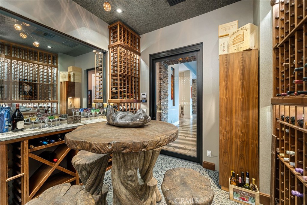 49967 Ridge View Way Palm Desert, CA 92260 - Photo 34 of 68 a view of a dining room with furniture and a chandelier