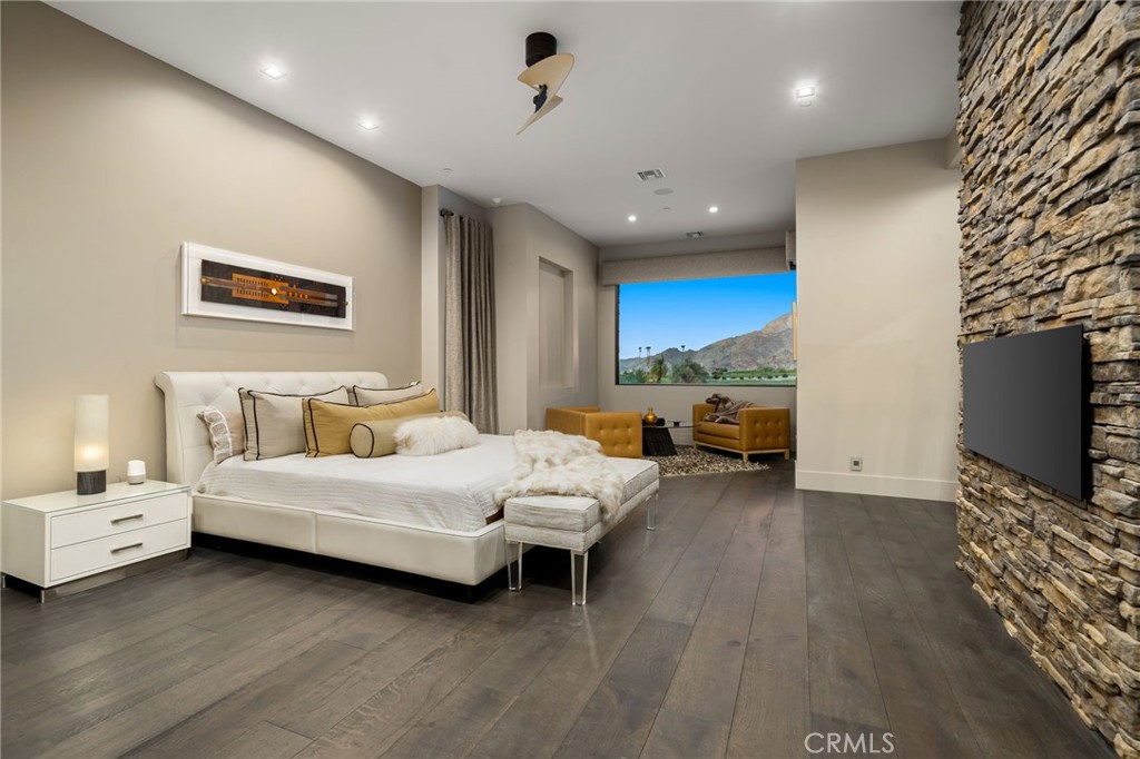 49967 Ridge View Way Palm Desert, CA 92260 - Photo 35 of 68 a spacious bedroom with a bed and a flat screen tv