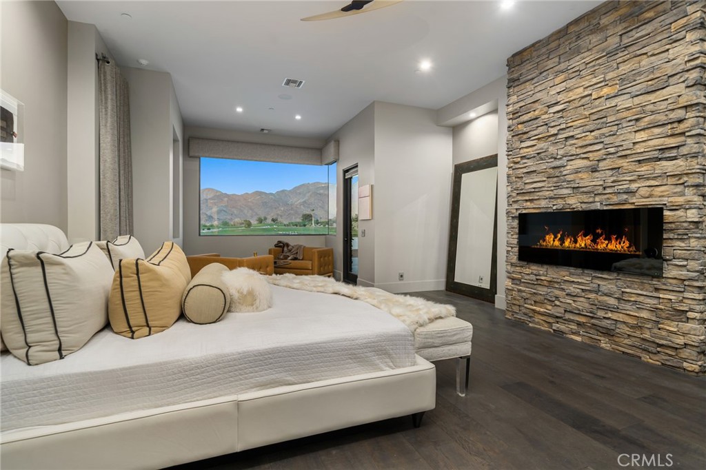 49967 Ridge View Way Palm Desert, CA 92260 - Photo 36 of 68 a bedroom with a bed a fireplace and a large window