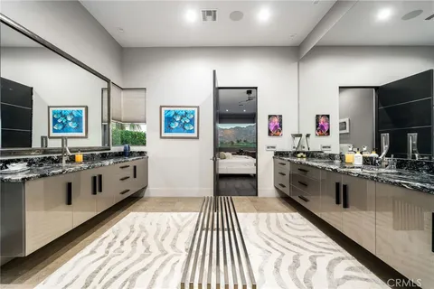 a spacious bedroom with a bed and a flat screen tv