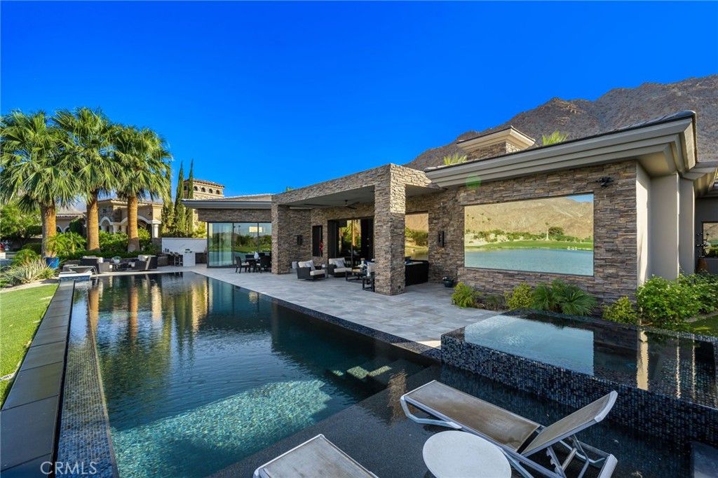 49967 Ridge View Way Palm Desert, CA 92260 - Photo 42 of 68 a view of a swimming pool with outdoor seating and plants