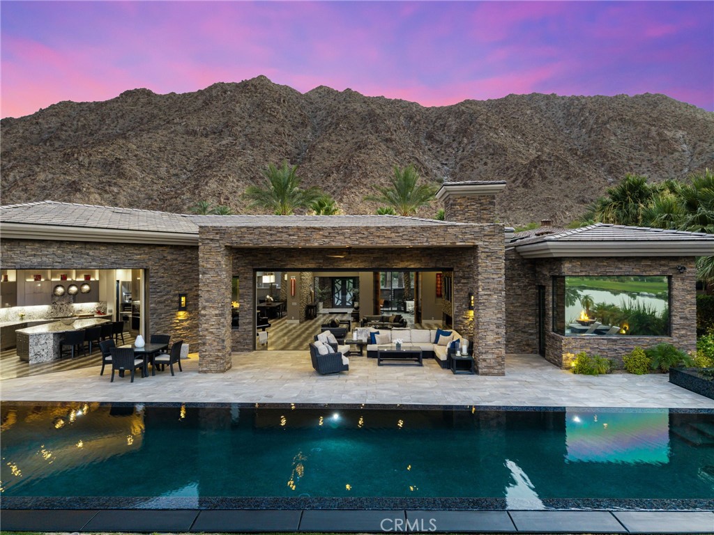 49967 Ridge View Way Palm Desert, CA 92260 - Photo 64 of 68 a view of swimming pool with outdoor seating and mountain view