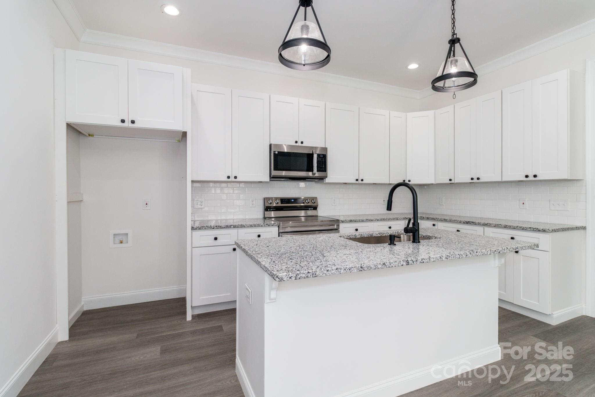 307 East Arch Street Lancaster, SC 29720 - Photo 17 of 43 a kitchen with appliances a sink and cabinets