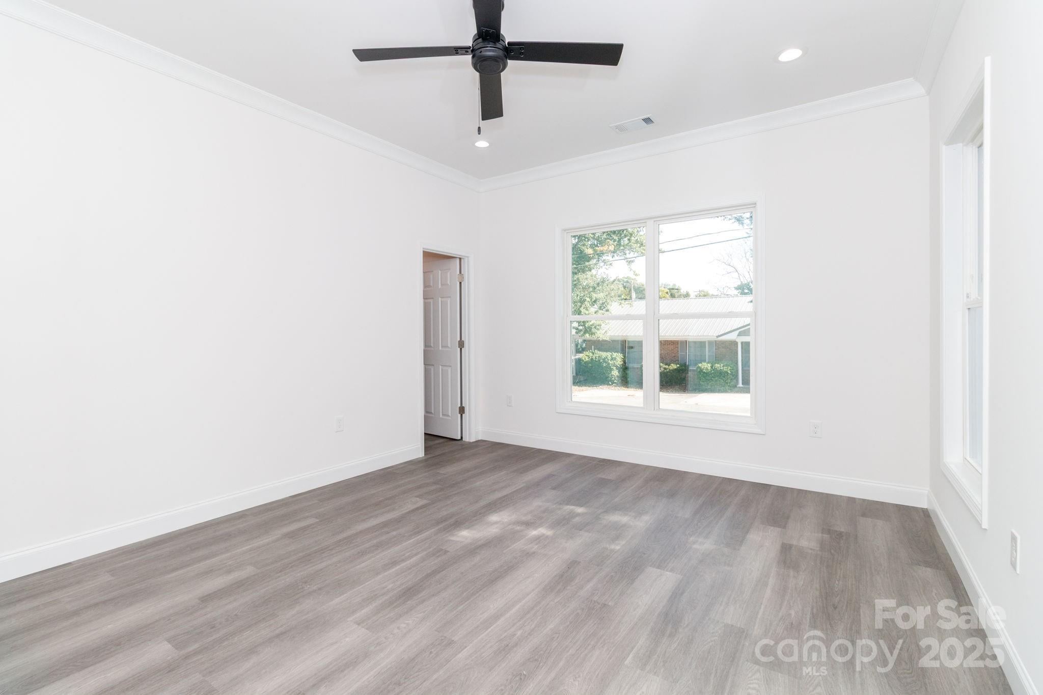 307 East Arch Street Lancaster, SC 29720 - Photo 24 of 43 a view of an empty room with wooden floor and a window