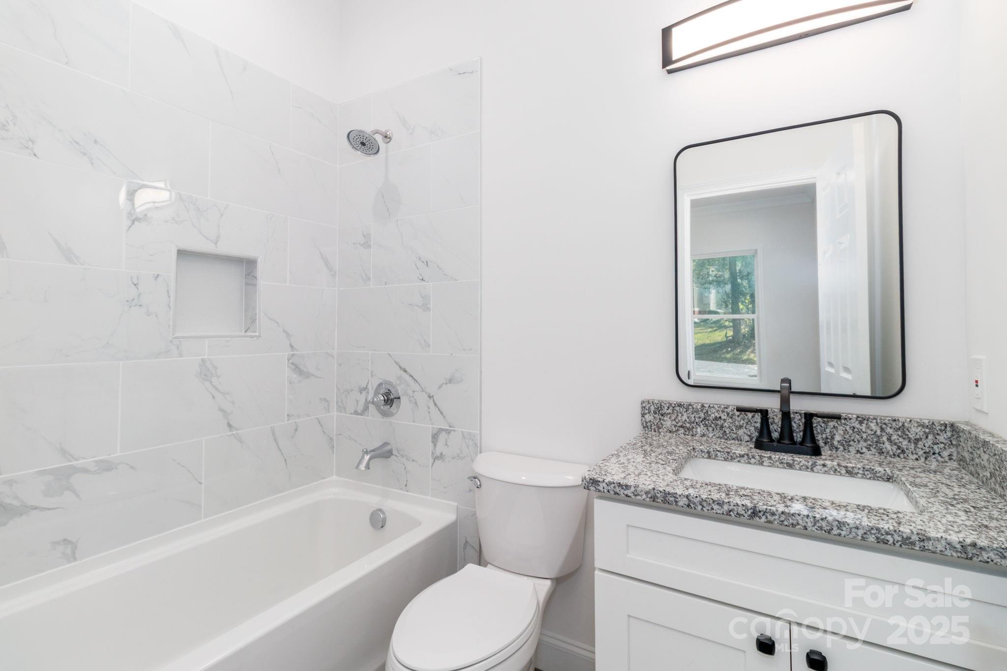 307 East Arch Street Lancaster, SC 29720 - Photo 27 of 43 a bathroom with a granite countertop sink a toilet and bathtub