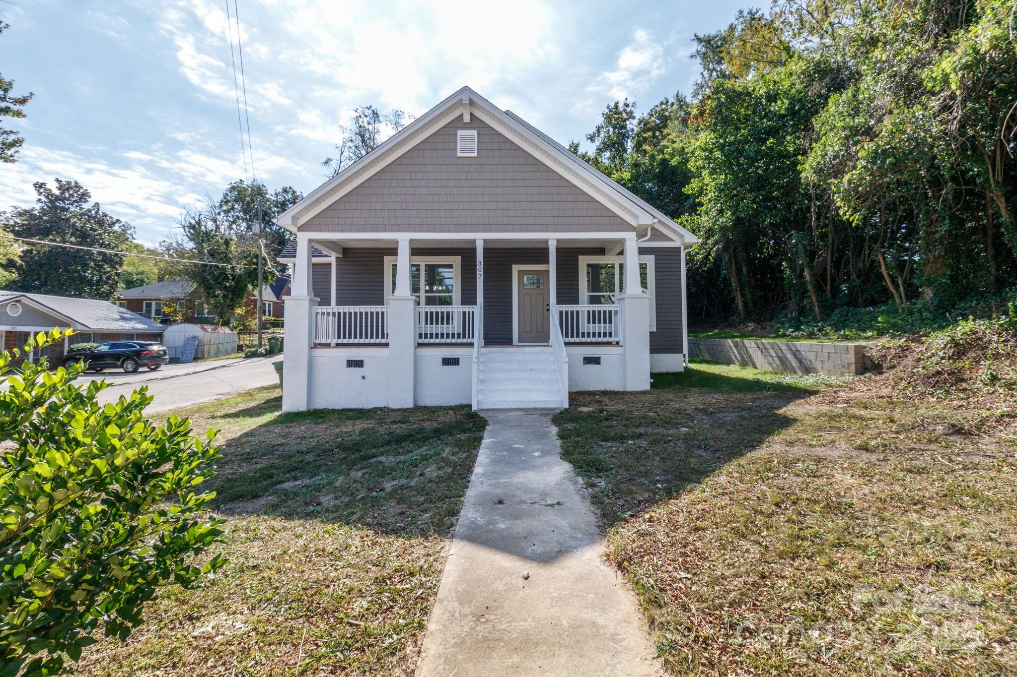 307 East Arch Street Lancaster, SC 29720 - Photo 3 of 43 a front view of a house with a yard and trees