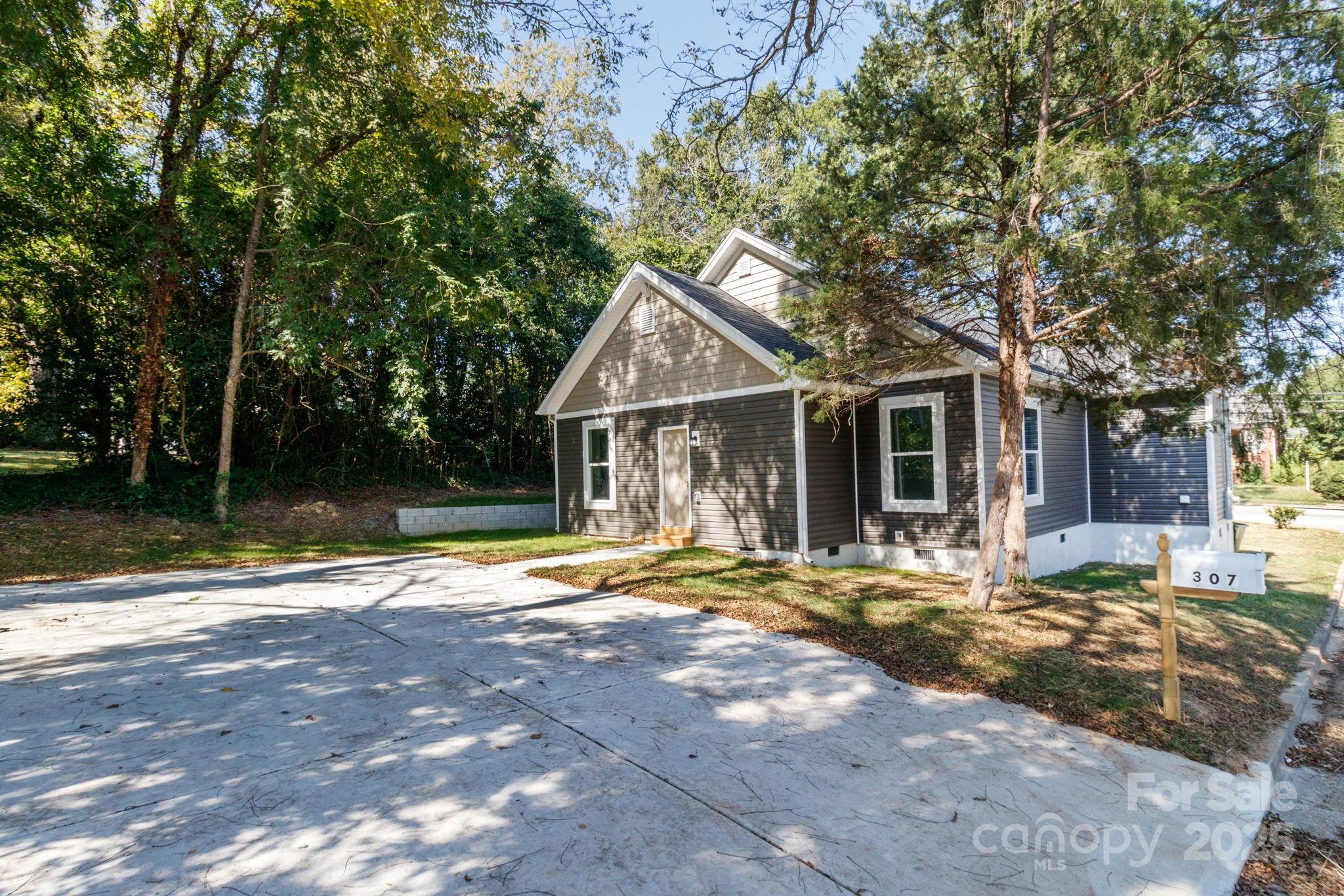 307 East Arch Street Lancaster, SC 29720 - Photo 38 of 43 a backyard of a house with yard and outdoor seating