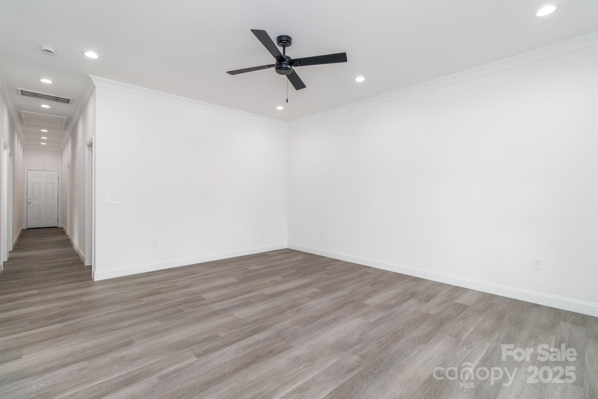307 East Arch Street Lancaster, SC 29720 - Photo 9 of 43 a view of a room with wooden floor and a ceiling fan
