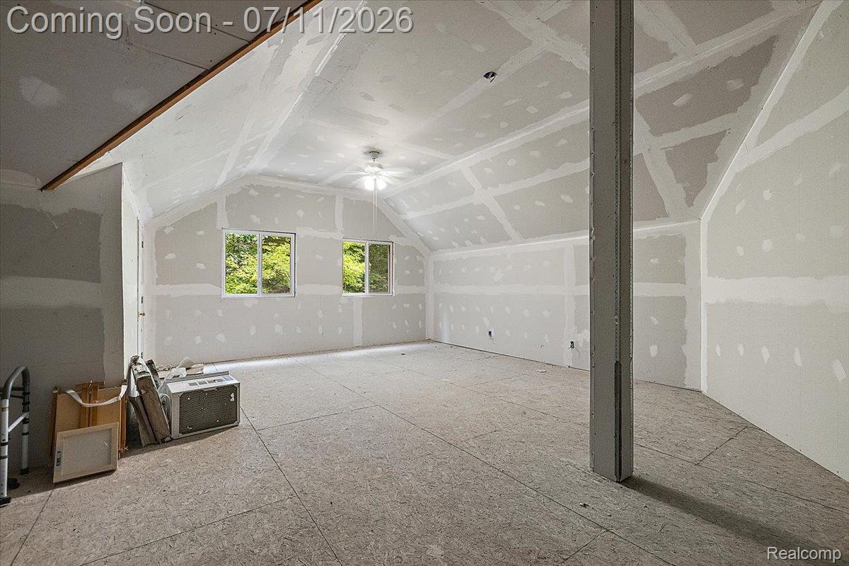 4219 Gardner Road Metamora, MI 48455 - Photo 64 of 87 Unfinished room featuring sloped ceilings, two windows, and a central ceiling fan