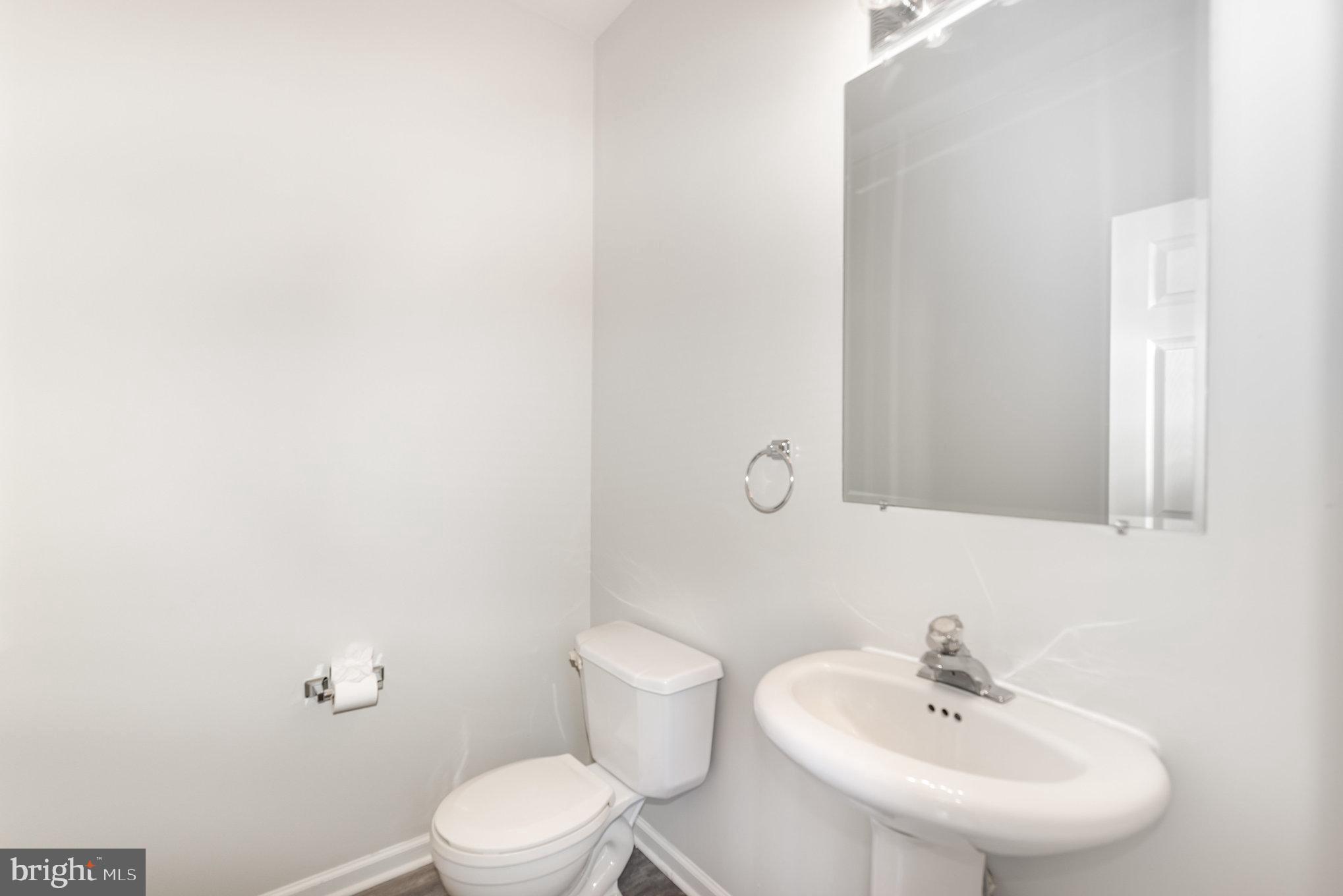 535 Oldfield Point Road Elkton, MD 21921 - Photo 13 of 46 a bathroom with a sink a toilet and mirror