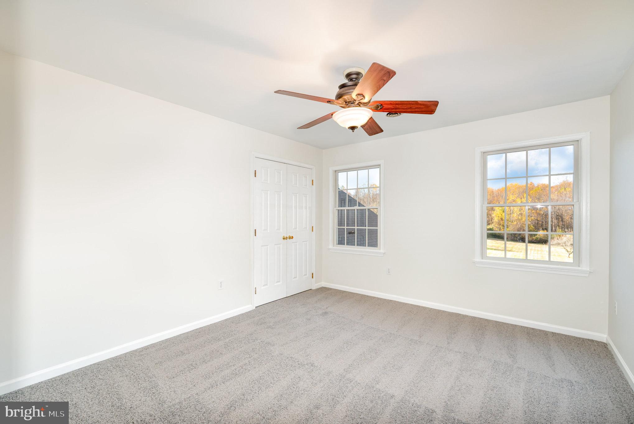 535 Oldfield Point Road Elkton, MD 21921 - Photo 22 of 46 an empty room with window and chandelier fan