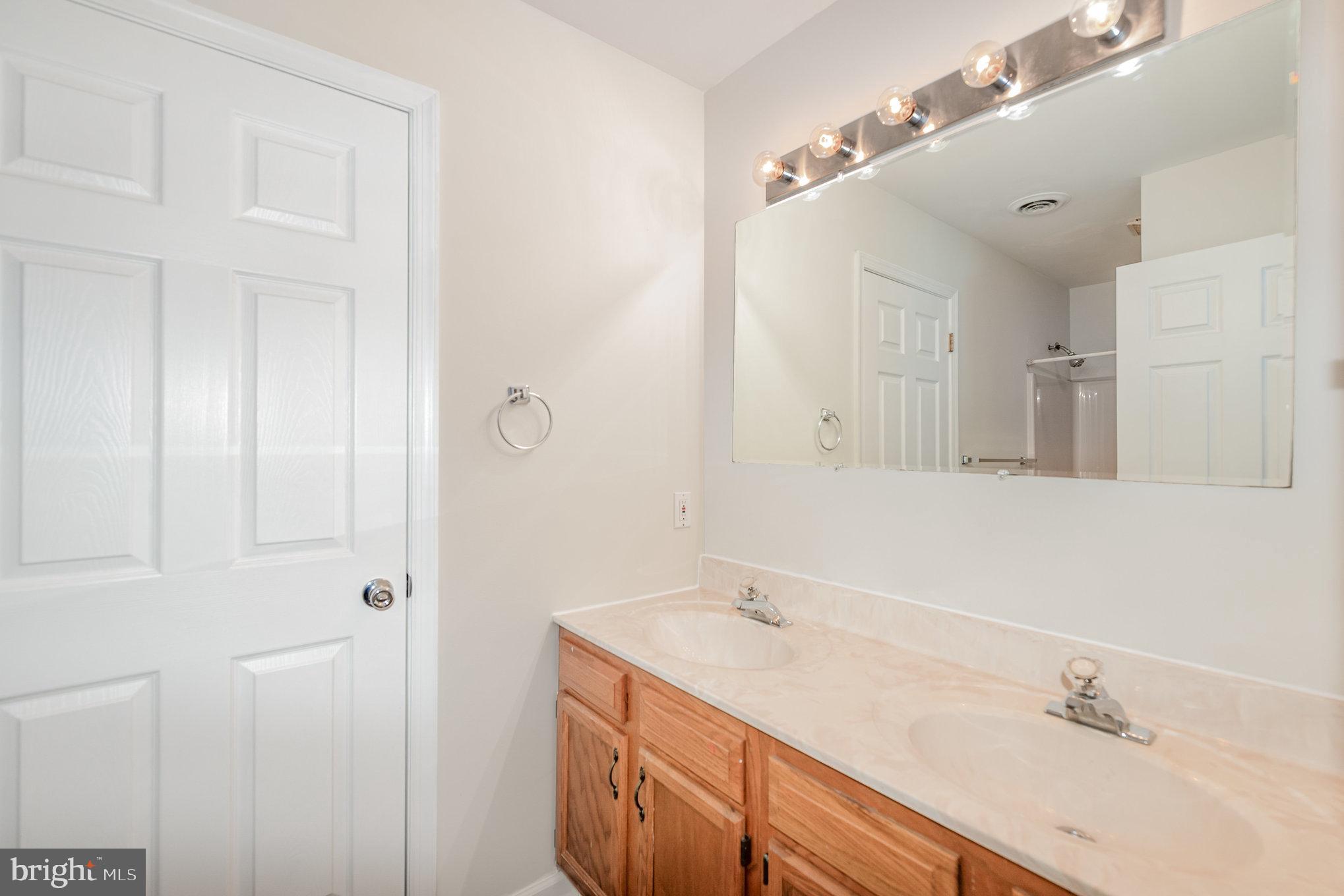 535 Oldfield Point Road Elkton, MD 21921 - Photo 24 of 46 a bathroom with a sink double vanity and a mirror