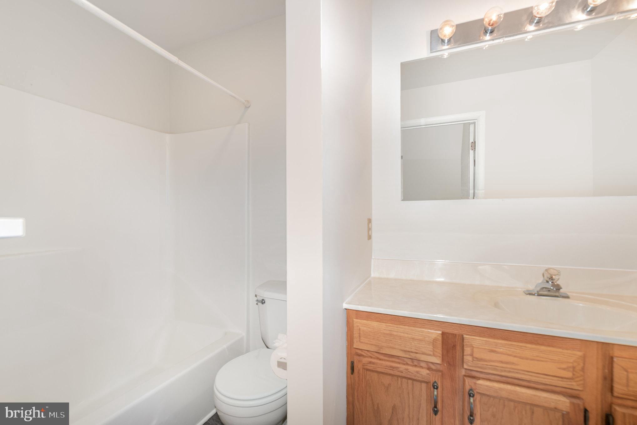 535 Oldfield Point Road Elkton, MD 21921 - Photo 26 of 46 a bathroom with a sink a toilet and vanity