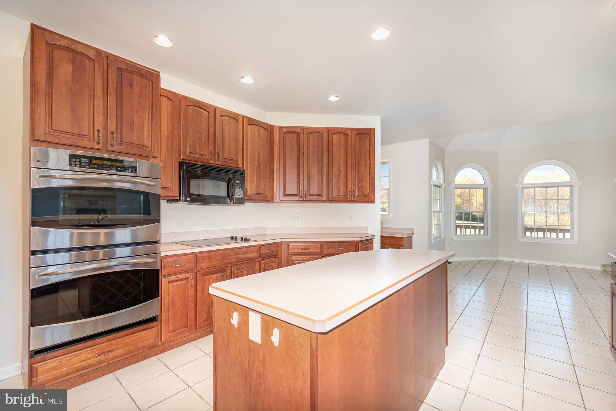 535 Oldfield Point Road Elkton, MD 21921 - Photo 9 of 46 a kitchen with stainless steel appliances granite countertop a stove a sink and a microwave