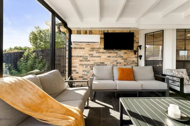 a living room with furniture fireplace and flat screen tv