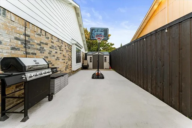 a backyard of a house with wooden fence