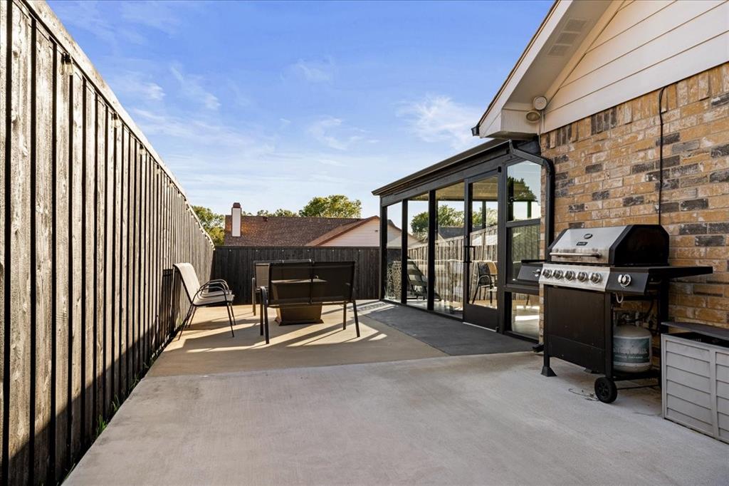 1208 Kesser Drive Plano, TX 75025 - Photo 18 of 33 Fenced backyard with a sunroom, area for grilling, and a patio