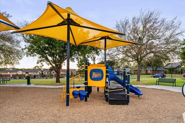 a view of park with slide and bench