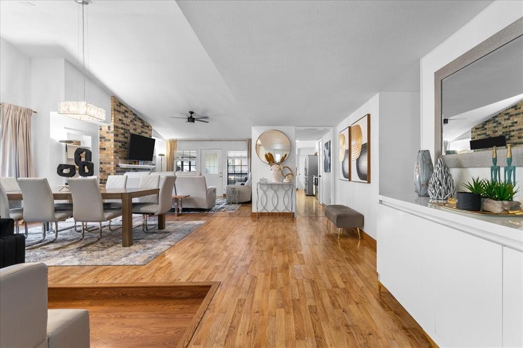 1208 Kesser Drive Plano, TX 75025 - Photo 5 of 33 Dining area featuring light wood-style floors, ceiling fan, and vaulted ceiling
