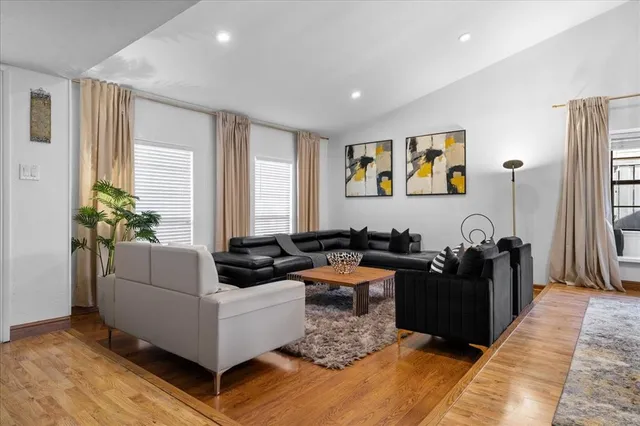 a living room with furniture potted plant and a window