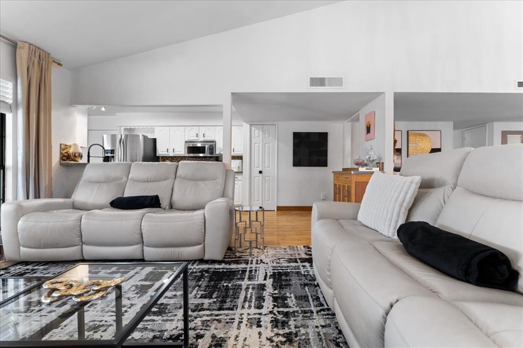 1208 Kesser Drive Plano, TX 75025 - Photo 10 of 33 Living room with light wood-style flooring and high vaulted ceiling