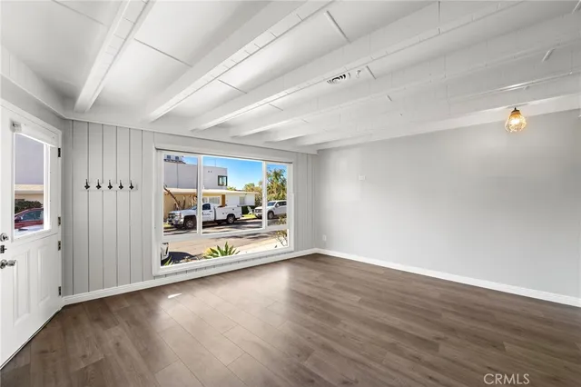 a view of a room with wooden floor and white walls