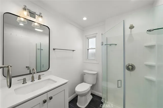 a bathroom with a toilet sink and shower