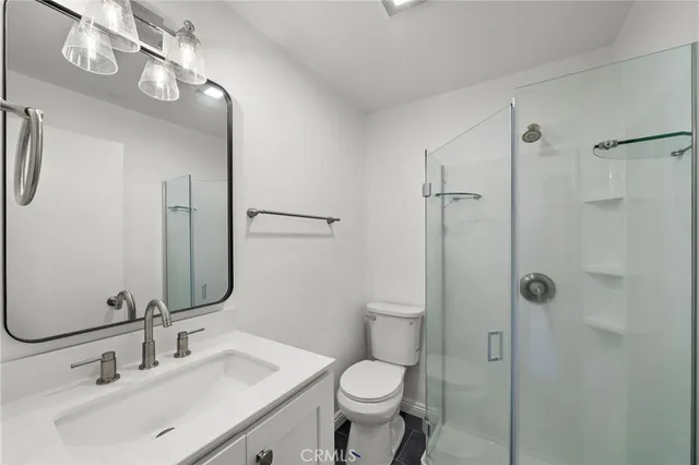 a bathroom with a toilet sink and shower