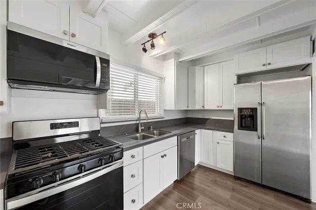 a kitchen with a sink stove and microwave