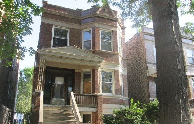 4132 West Cermak Road Chicago, IL 60623 - Photo 2 of 13 a view of a brick house with a large window and large tree
