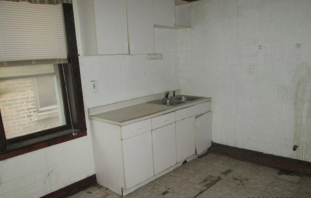 4132 West Cermak Road Chicago, IL 60623 - Photo 10 of 13 a utility room with cabinets washer and dryer