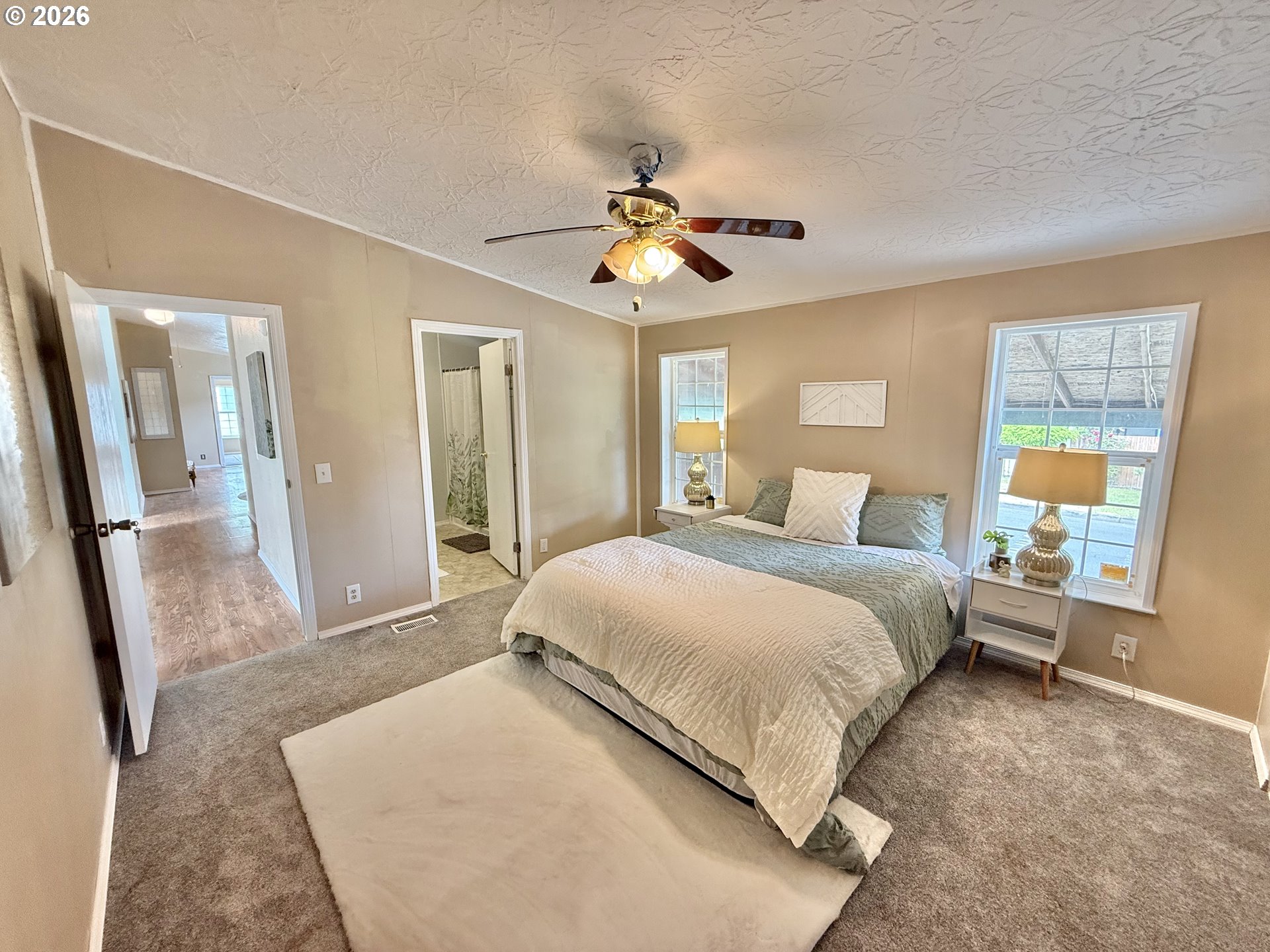 1282 3rd Street, Unit 37 Lafayette, OR 97127 - Photo 10 of 28 a bedroom with a large bed and a chandelier