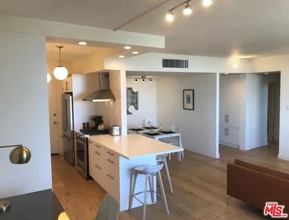 a kitchen with a table and chairs