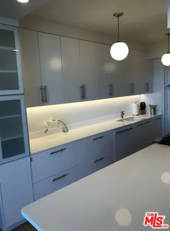 a kitchen with a sink and cabinets