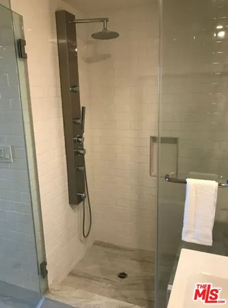 a bathroom with a glass shower door