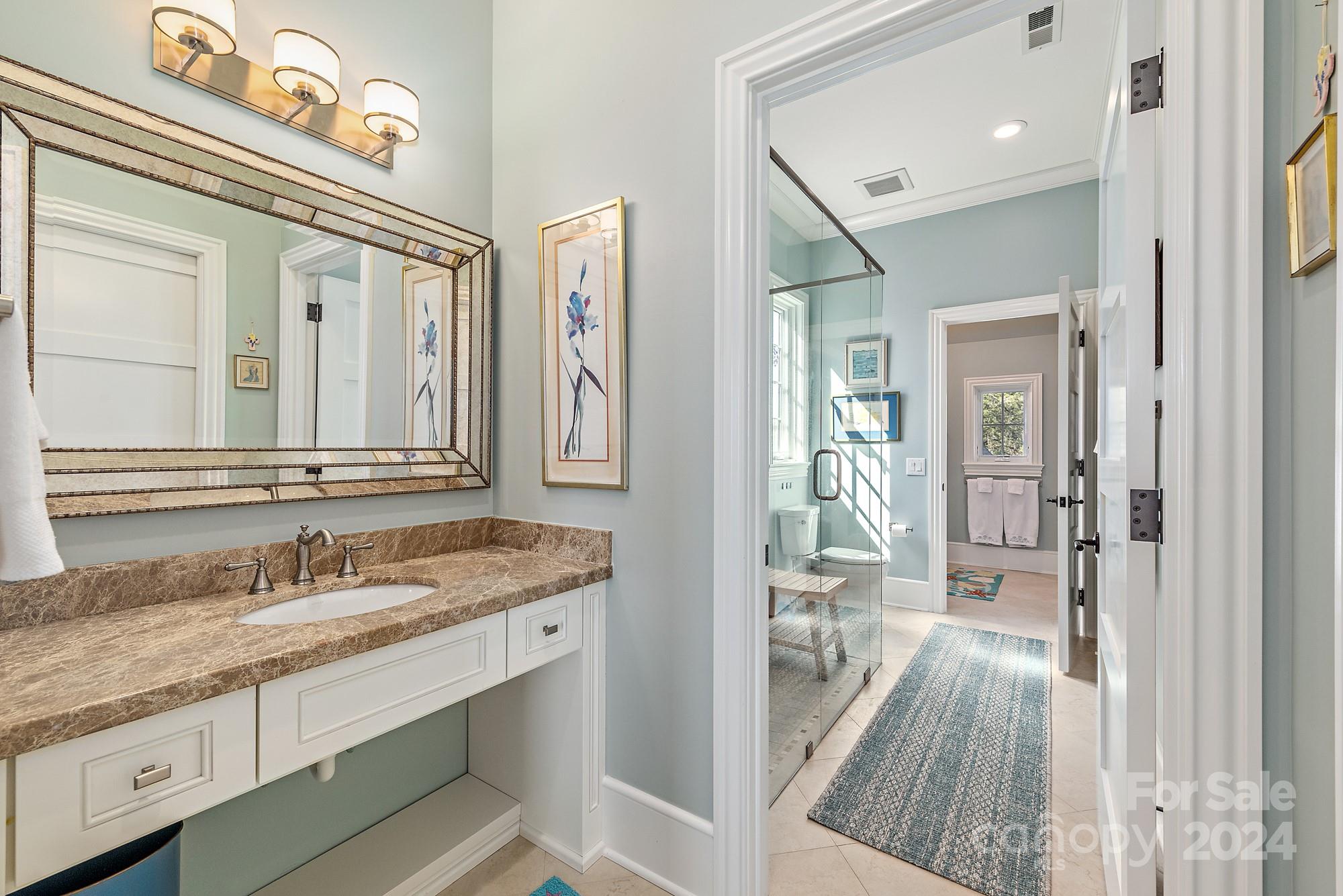 165 Timberside Drive Davidson, NC 28036 - Photo 28 of 48 a en suite bathroom with a granite countertop sink a mirror and a shower