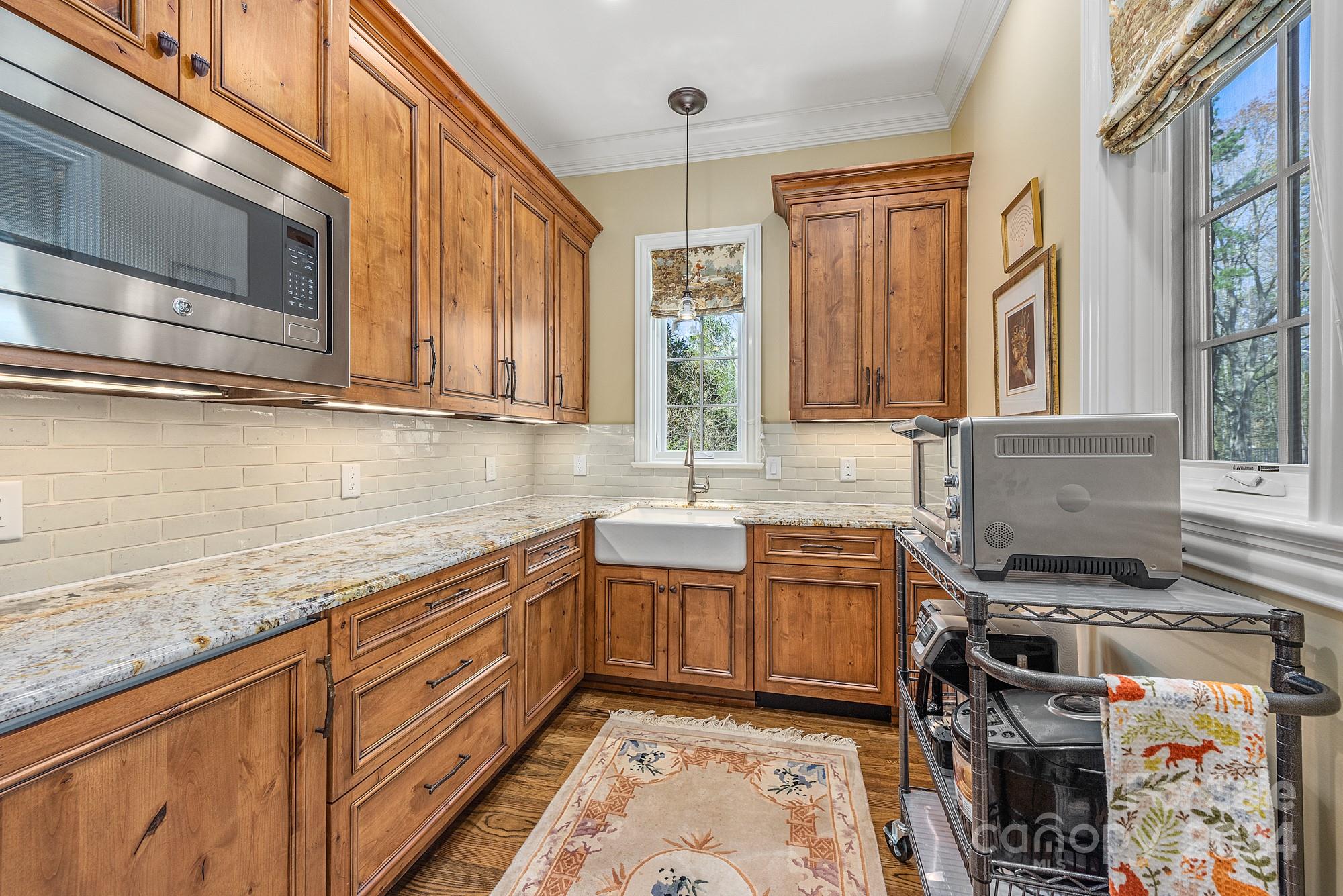 165 Timberside Drive Davidson, NC 28036 - Photo 42 of 48 a kitchen with stainless steel appliances granite countertop a stove and a sink