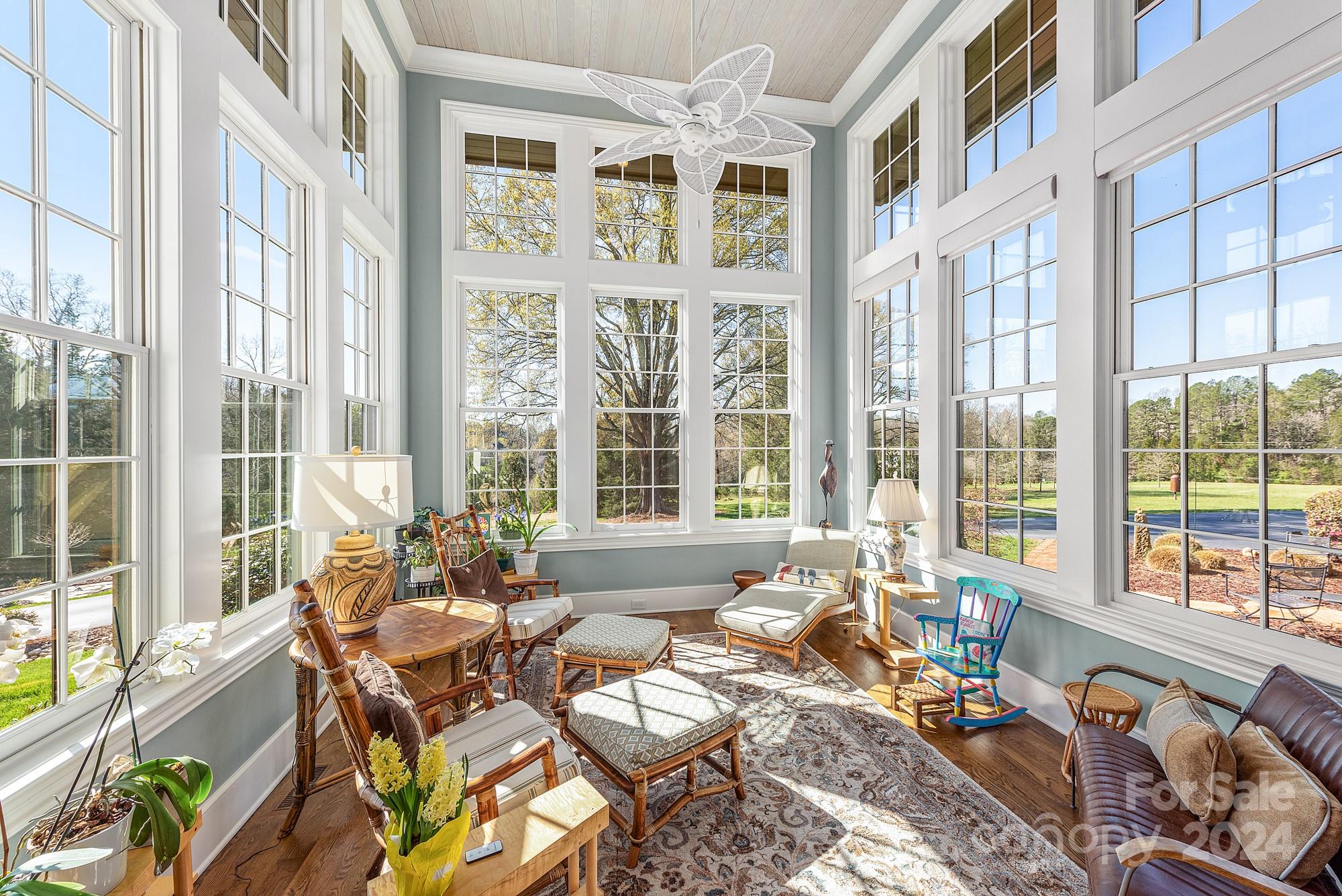 165 Timberside Drive Davidson, NC 28036 - Photo 6 of 48 a living room filled with furniture and floor to ceiling windows
