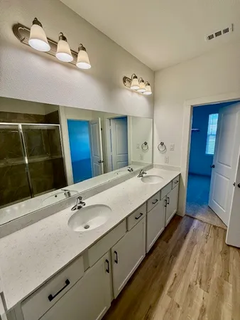 a bathroom with a glass shower door