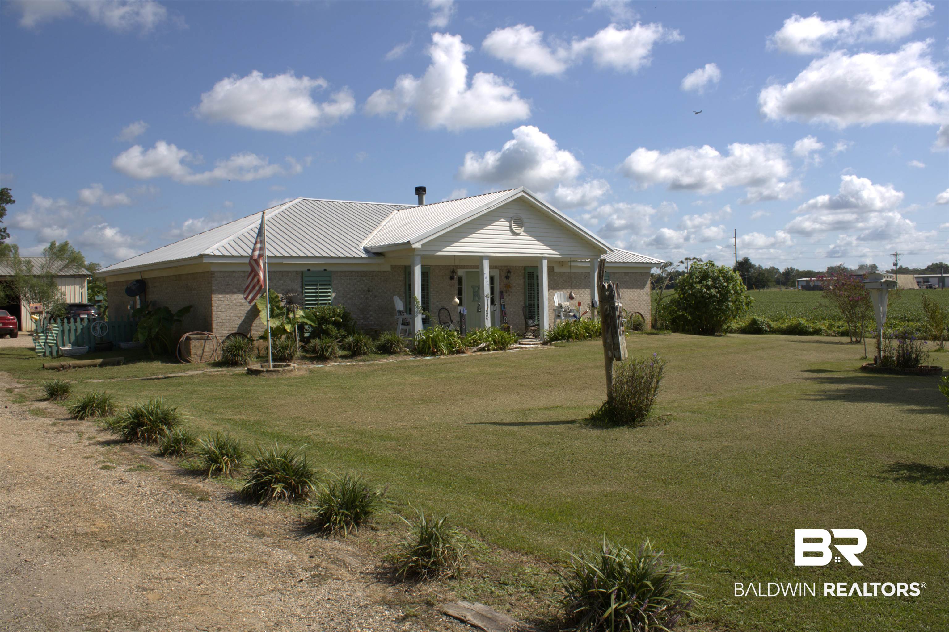 7851 Highway 98 Fairhope, AL 36532 - Photo 2 of 40 View of front of house featuring a front yard, brick siding, and a porch