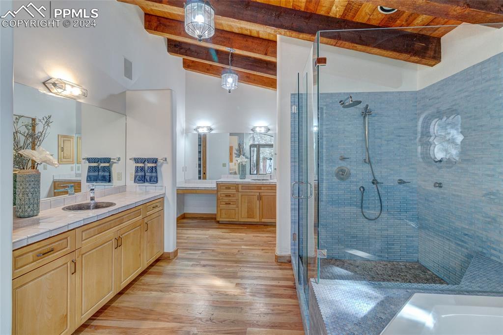 15 4th Street Colorado Springs, CO 80906 - Photo 34 of 46 a bathroom with a double vanity sink a mirror and shower