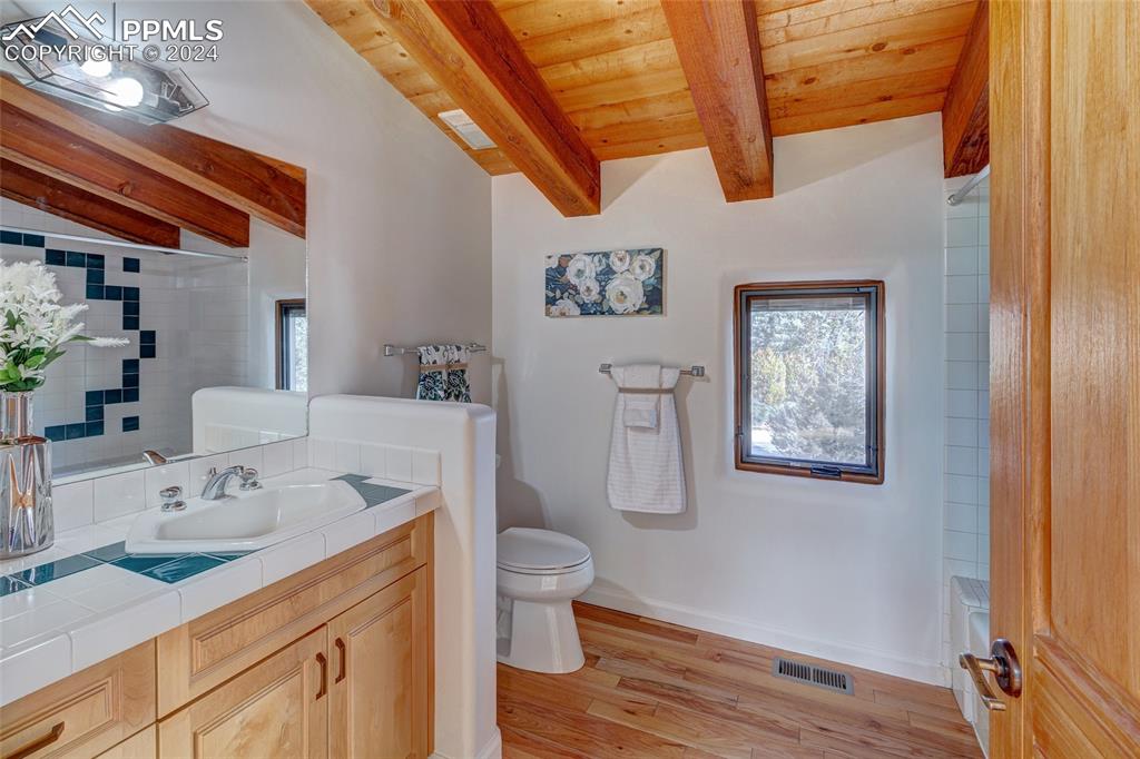15 4th Street Colorado Springs, CO 80906 - Photo 42 of 46 a bathroom with a sink mirror vanity and toilet