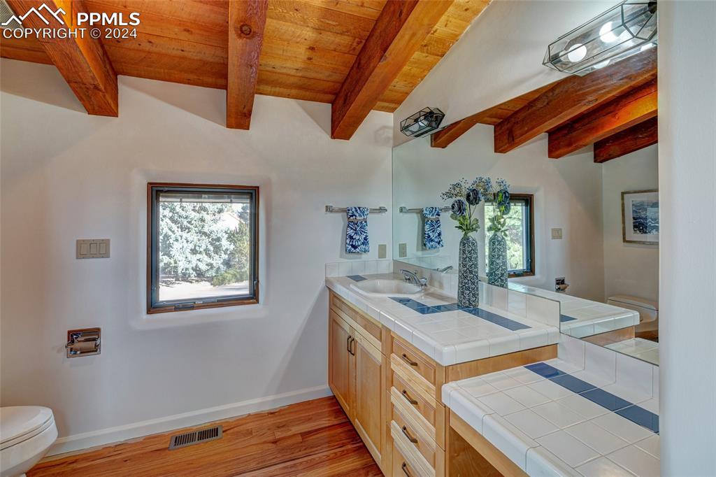 15 4th Street Colorado Springs, CO 80906 - Photo 45 of 46 a kitchen with stainless steel appliances granite countertop a stove and a wooden floor