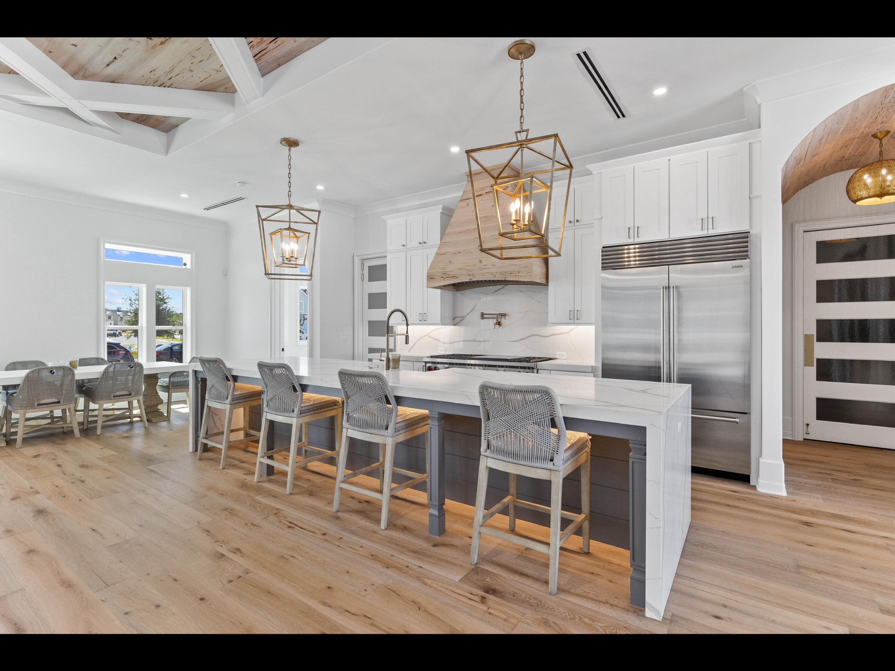 19 Quail Hollow Inlet Beach, FL 32461 - Photo 56 of 84 a kitchen with stainless steel appliances kitchen island granite countertop a table chairs sink and cabinets
