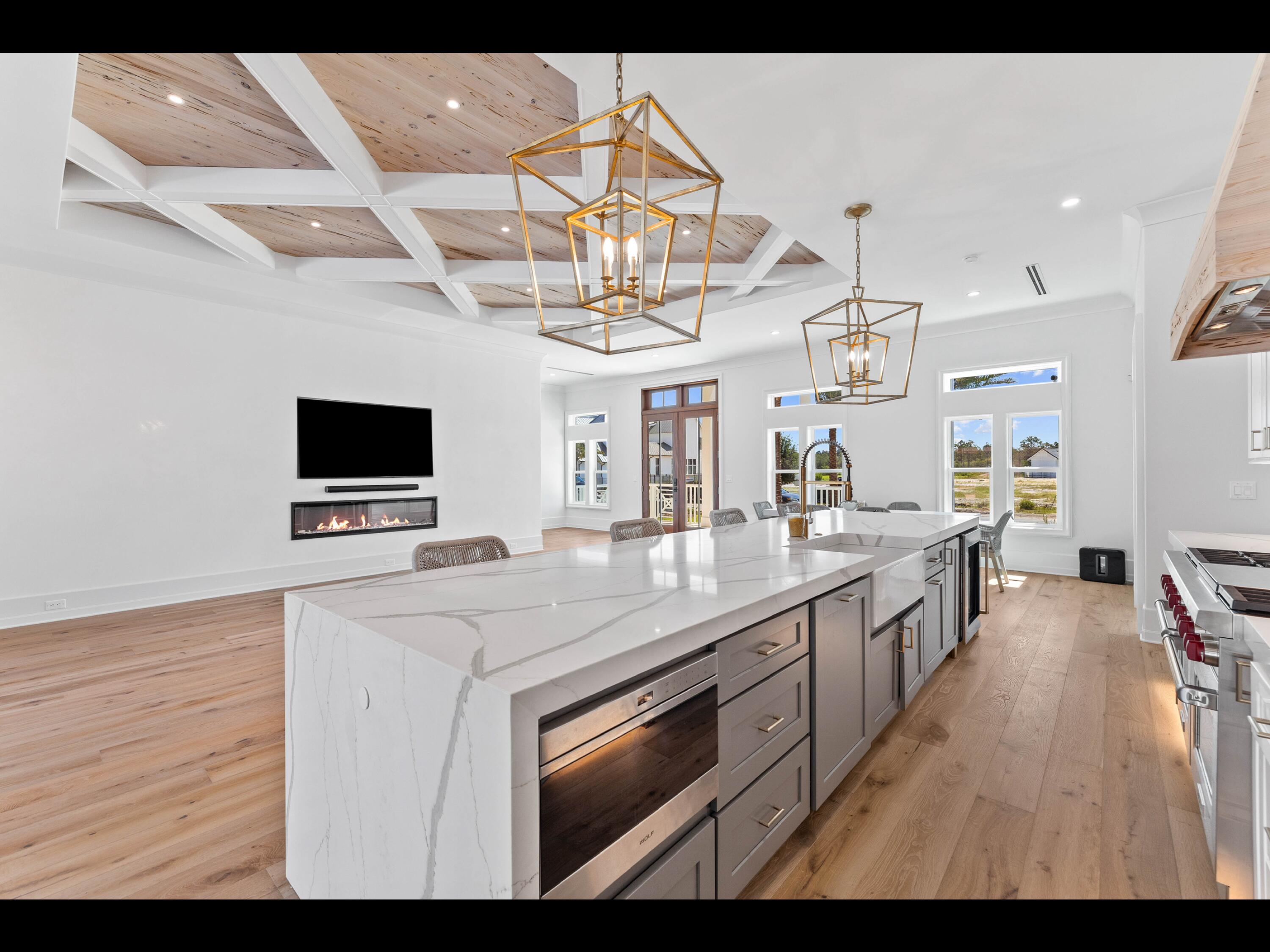 19 Quail Hollow Inlet Beach, FL 32461 - Photo 57 of 84 a kitchen with stainless steel appliances kitchen island granite countertop a sink dishwasher a dining table and chairs with wooden floor