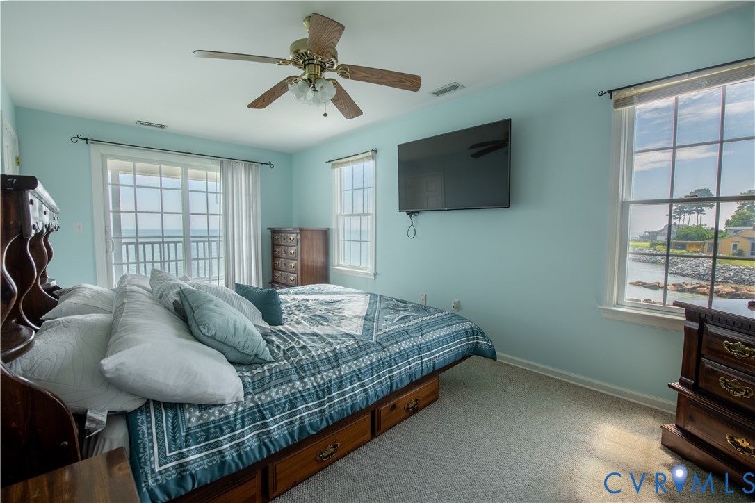 154 Riverside Drive Deltaville, VA 23043 - Photo 23 of 38 a bed sitting in a bedroom next to a window