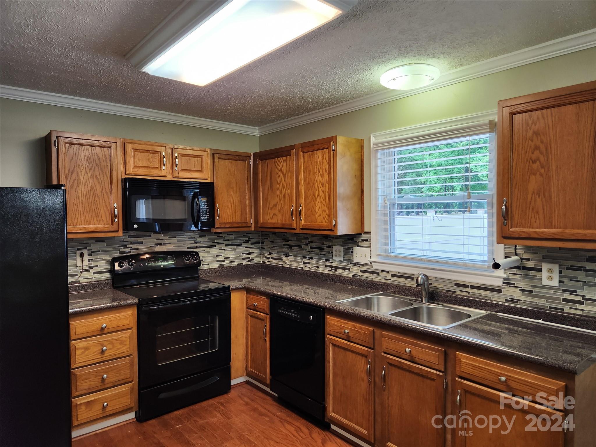 1201 Scaleybark Road, Unit D Charlotte, NC 28209 - Photo 12 of 37 a kitchen with granite countertop a sink stainless steel appliances and cabinets