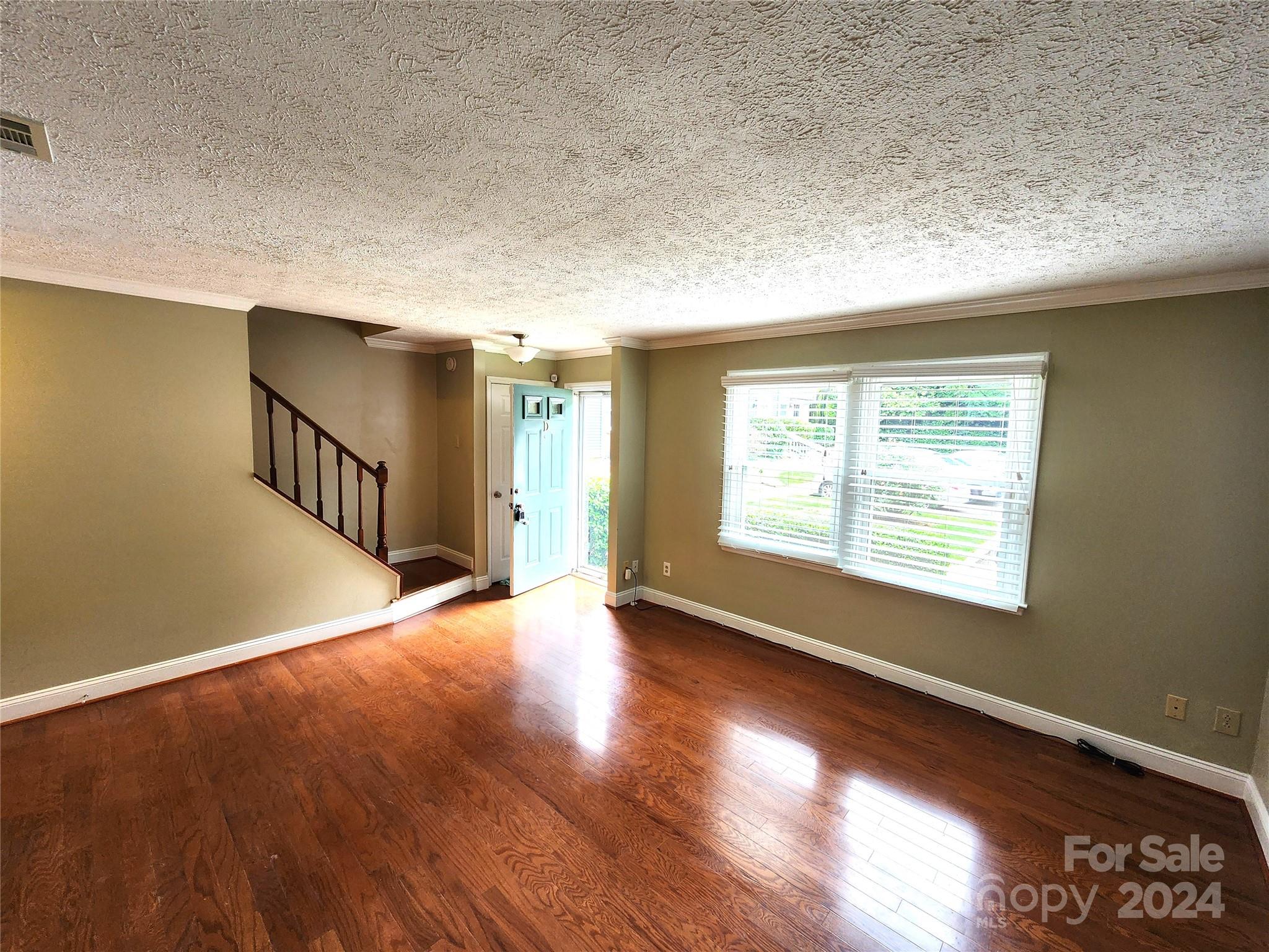 1201 Scaleybark Road, Unit D Charlotte, NC 28209 - Photo 13 of 37 a view of an empty room with wooden floor and a window